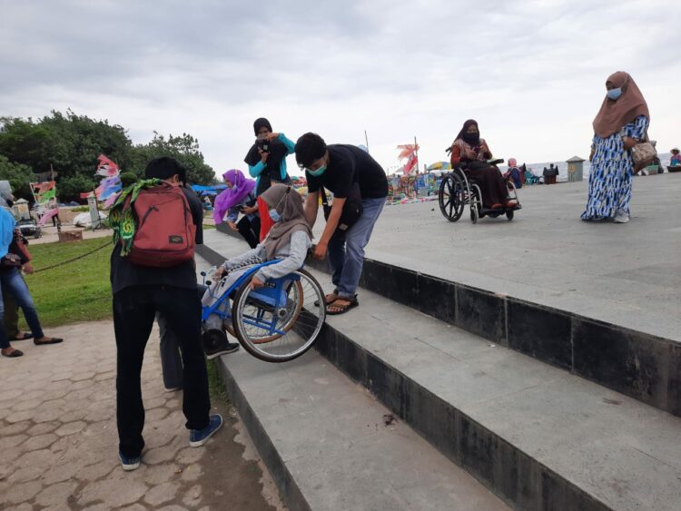 HWDI Sumbar mencoba fasilitas yang ada di Pantai Padang menggunakan kursi roda. (foto: Rahmadi/langgam.id)