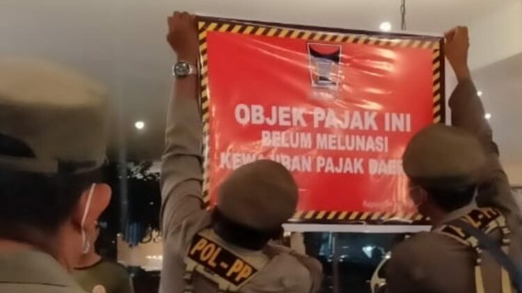 Tim gabungan Pemko Padang pasangi stiker menunggak pajak. (Foto: Dok. Satpol PP Padang)