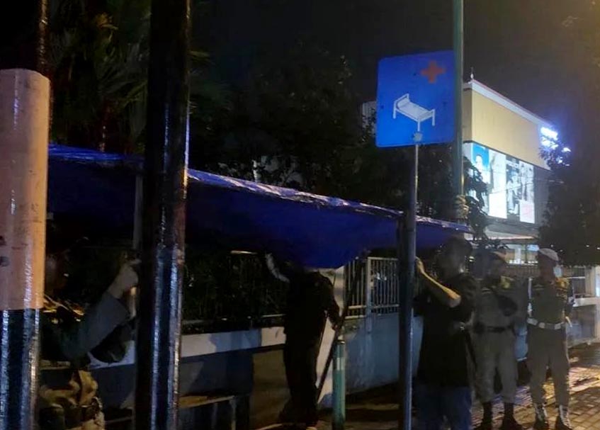 Langgam.id - Personel Satpol PP membongkar lapak-lapak Pedagang Kaki Lima (PKL) yang ditinggal bermalam di atas trotoar di kawasn Tarandam.