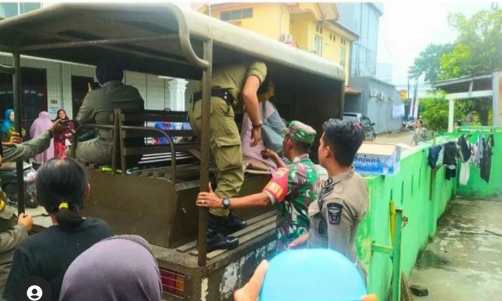 Personel Satpol PP Kota Padang mengamankan seorang perempuan paruh baya karena diduga telah meresahkan peserta Penas Tani