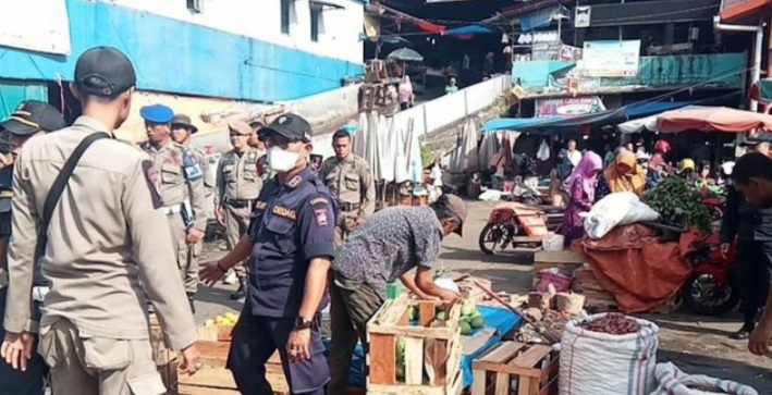 Satuan Polisi Pamong Praja (Satpol PP) Kota Padang menertibkan para pedagang yang berjualan di halaman parkiran Pasar Bandar Buat,